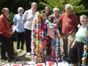 Members of Univ Friends Meeting decorate Sadako statue at Peace Park with cranes folded by students from Connecticut